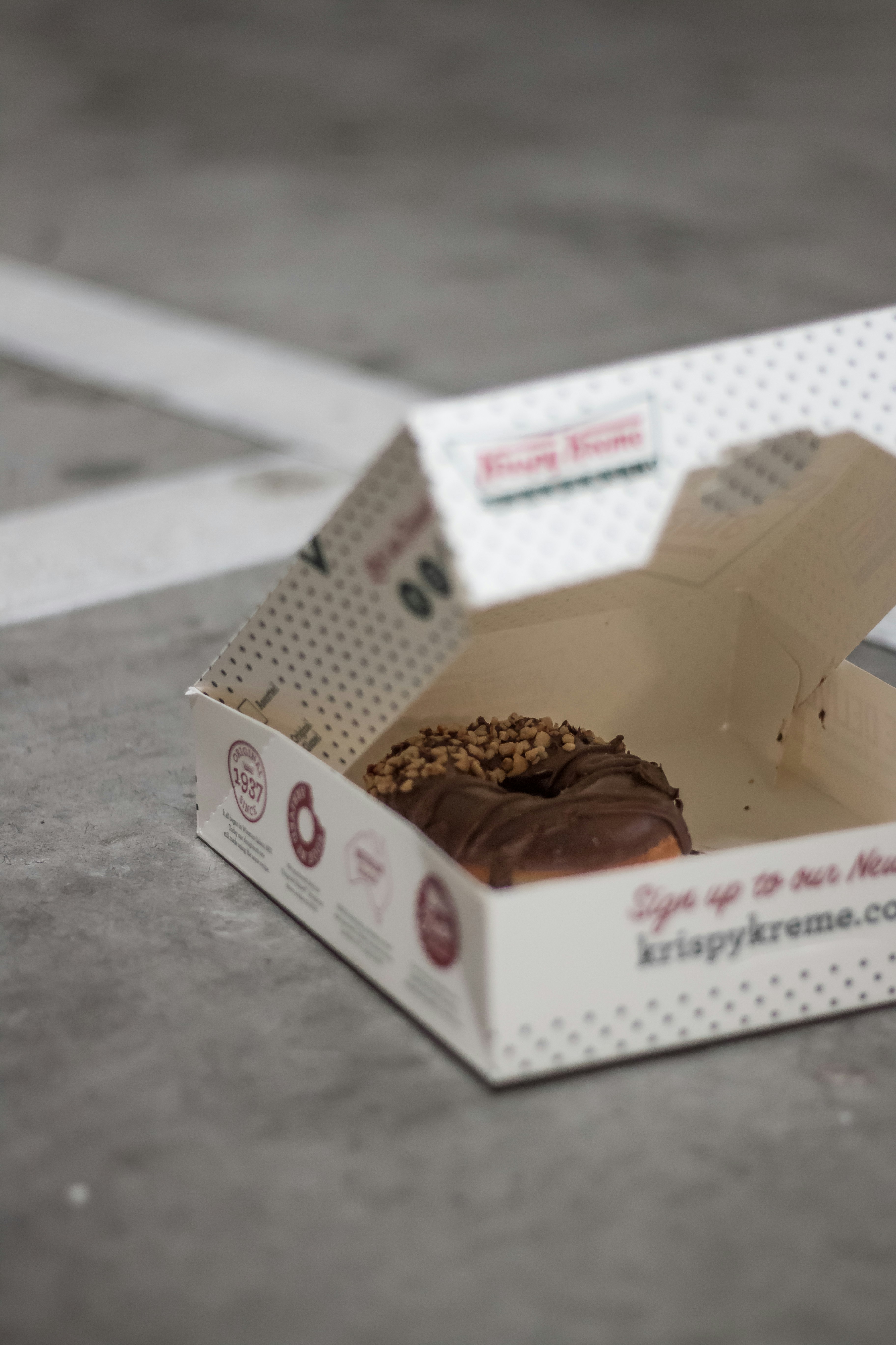 chocolate covered Krispy Kreme donut with box